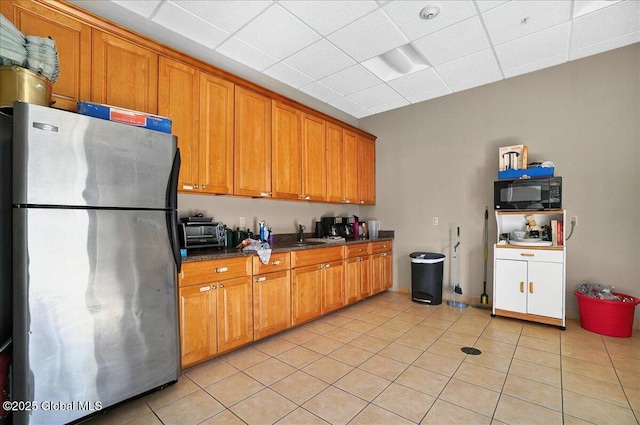 8 Wall St Apt 200, Clifton Park, NY 12065 - kitchen with freestanding refrigerator, black microwave, brown cabinetry, and a drop ceiling
