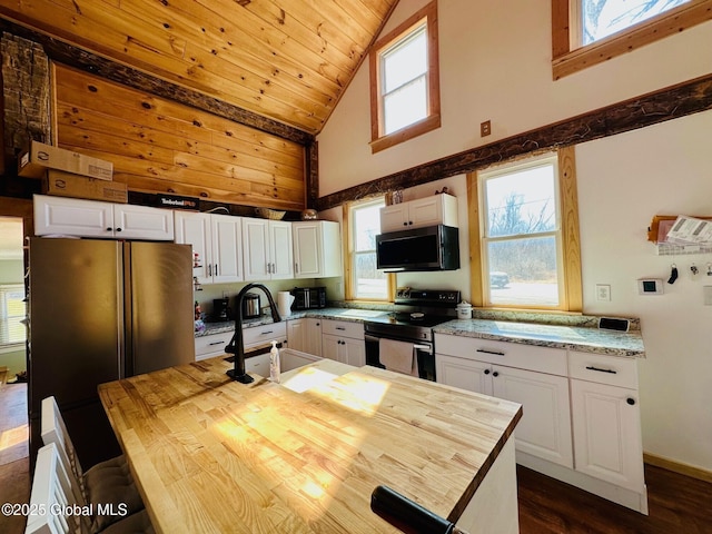 kitchen with electric stove, a sink, white cabinets, and high vaulted ceiling