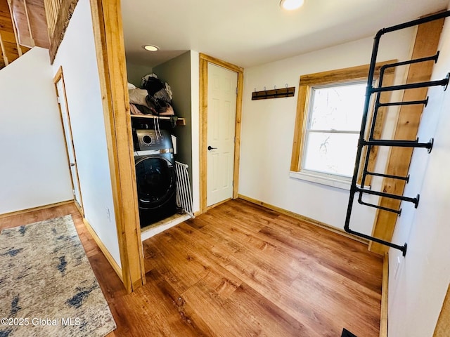 laundry area with laundry area, washer / clothes dryer, wood finished floors, baseboards, and recessed lighting