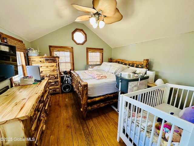 bedroom featuring a ceiling fan, hardwood / wood-style flooring, and lofted ceiling