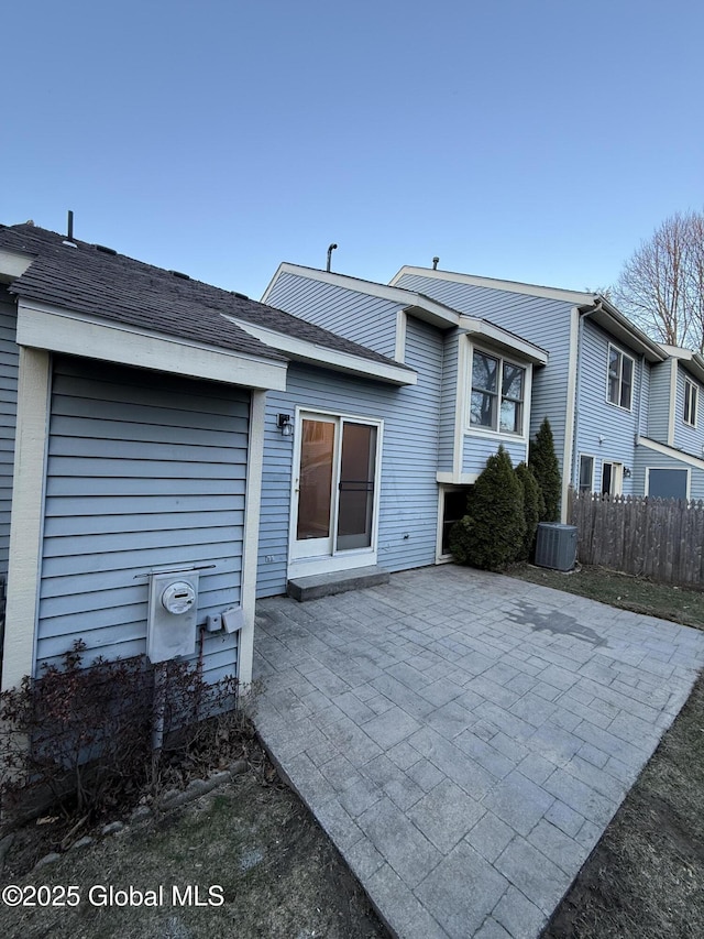 rear view of house with fence and a patio