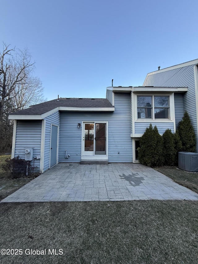 rear view of house with cooling unit and a patio area
