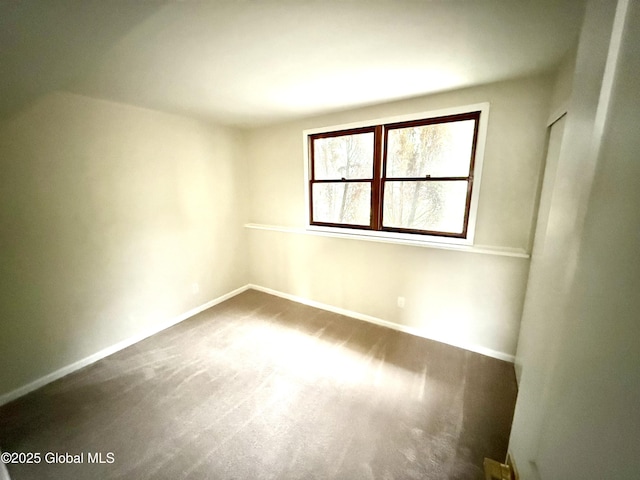 carpeted empty room with baseboards