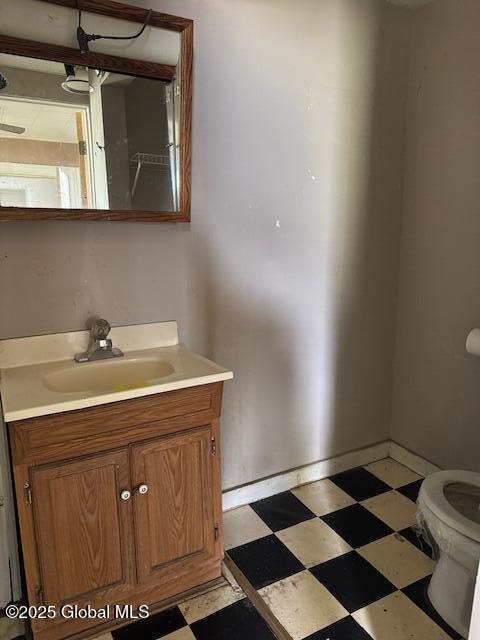 25 N Perry St, Johnstown, NY 12095 - half bath featuring baseboards, toilet, tile patterned floors, and vanity