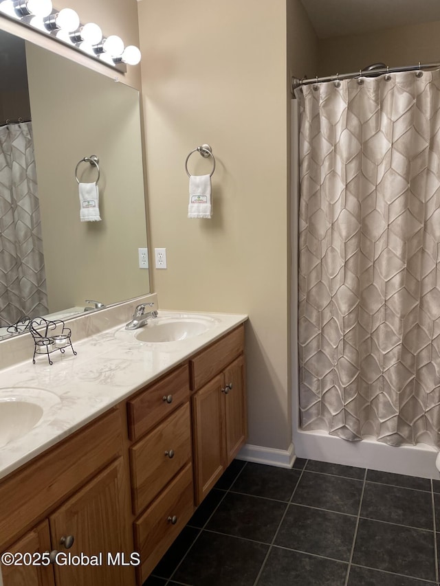 bathroom with tile patterned flooring, a sink, double vanity, and a shower with shower curtain