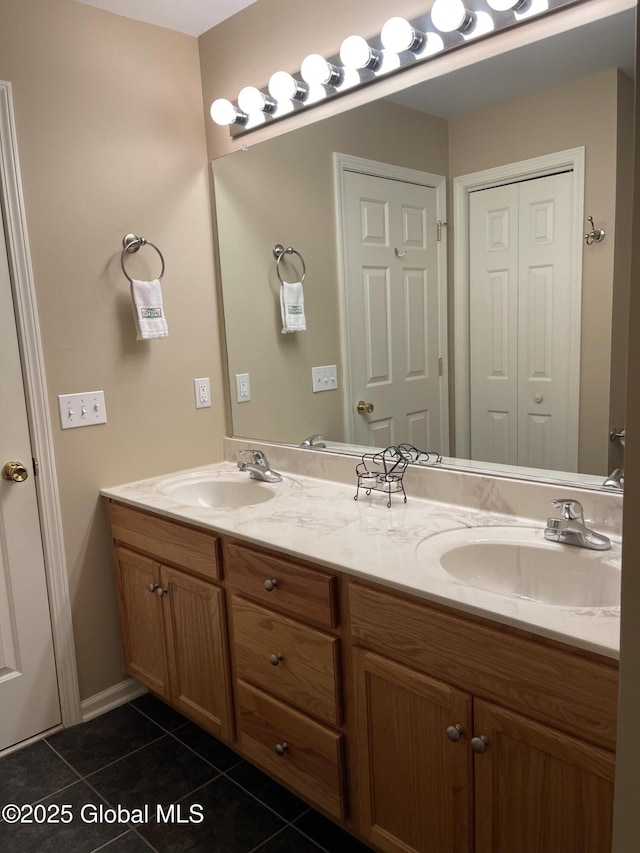 bathroom with double vanity, tile patterned flooring, and a sink