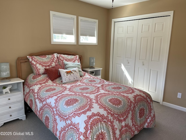 carpeted bedroom with baseboards and a closet