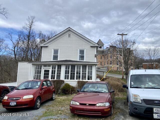 view of front of house featuring a sunroom