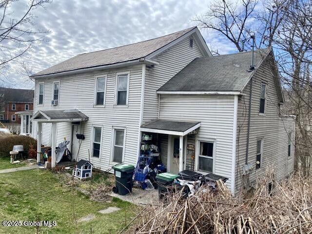 back of property with a yard