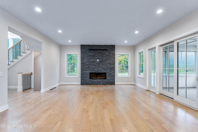 unfurnished living room featuring light wood finished floors, recessed lighting, and a healthy amount of sunlight