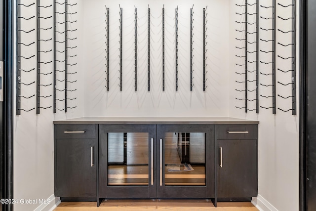 bar with light wood finished floors and baseboards