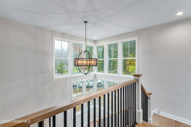 interior space featuring baseboards, an inviting chandelier, and recessed lighting