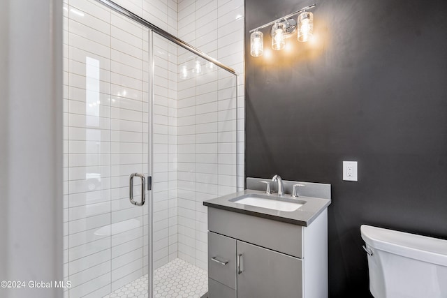 full bathroom with toilet, a stall shower, and vanity