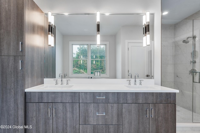 full bath with double vanity, a sink, and a stall shower