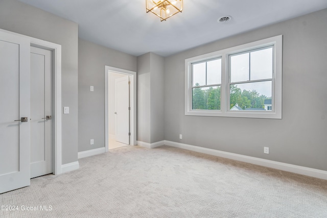 unfurnished bedroom with baseboards, carpet flooring, and visible vents