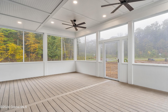 unfurnished sunroom with ceiling fan