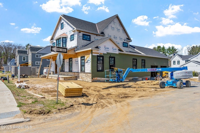 unfinished property featuring a shingled roof