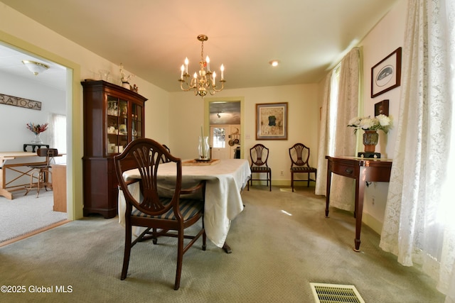 21 Andrews St, Saratoga Springs, NY 12866 - dining area featuring plenty of natural light, light colored carpet, a notable chandelier, and visible vents