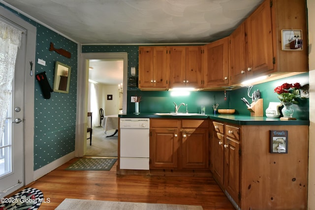21 Andrews St, Saratoga Springs, NY 12866 - kitchen with hardwood / wood-style floors, wallpapered walls, a sink, white dishwasher, and brown cabinetry