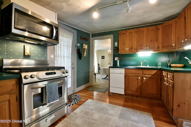 21 Andrews St, Saratoga Springs, NY 12866 - kitchen with a sink, wallpapered walls, wood finished floors, and appliances with stainless steel finishes