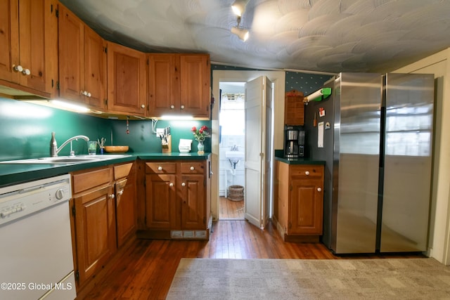 21 Andrews St, Saratoga Springs, NY 12866 - kitchen with wood finished floors, freestanding refrigerator, a sink, dishwasher, and brown cabinets