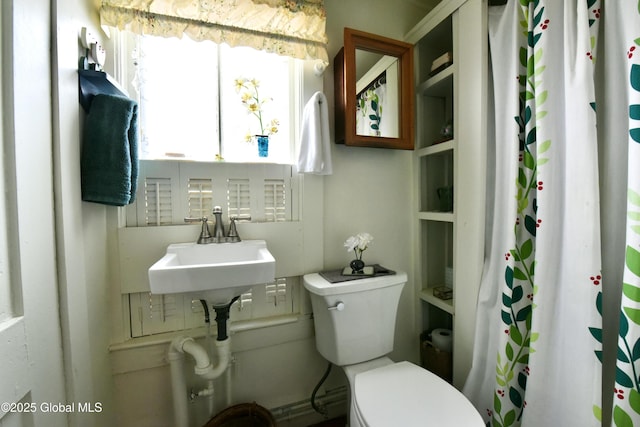 21 Andrews St, Saratoga Springs, NY 12866 - bathroom featuring a sink, toilet, and a shower with curtain