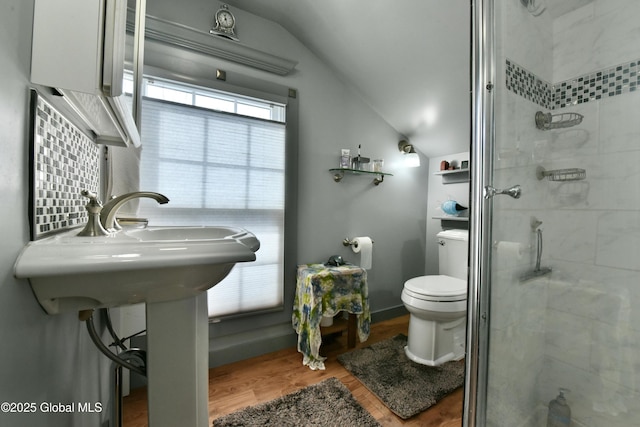 21 Andrews St, Saratoga Springs, NY 12866 - bathroom with lofted ceiling, wood finished floors, a stall shower, and toilet
