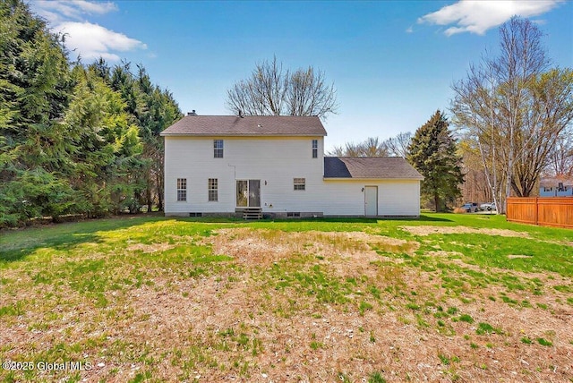 back of house with a lawn, fence, and entry steps
