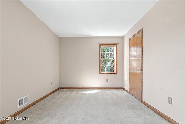 unfurnished room with baseboards, carpet, and visible vents