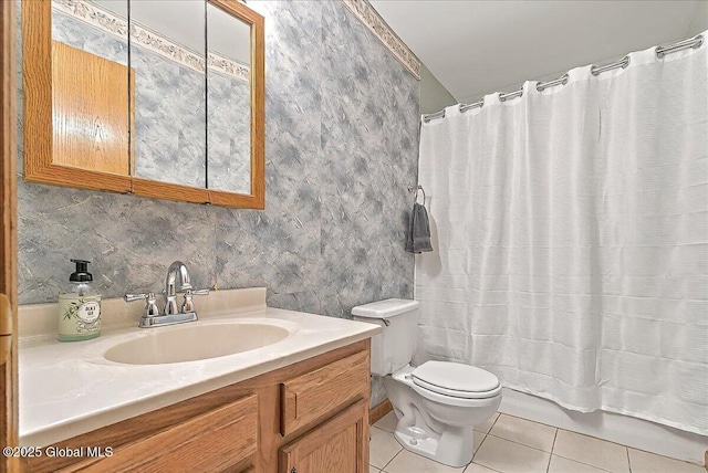 full bathroom featuring vanity, tile patterned flooring, shower / bath combo with shower curtain, and toilet