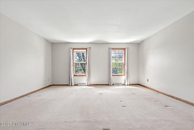 carpeted spare room with baseboards