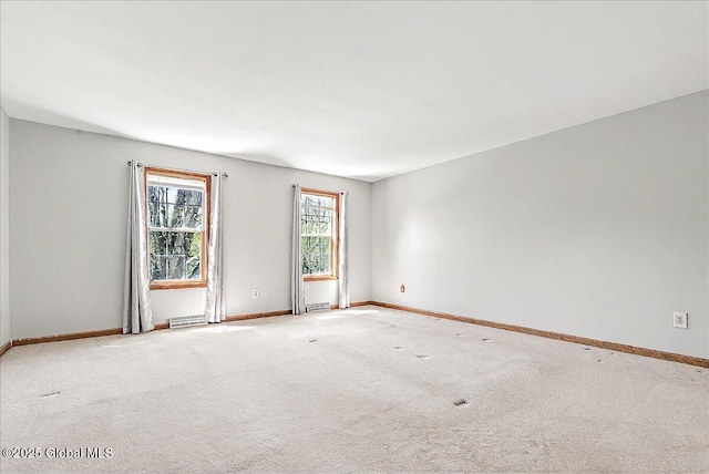 carpeted empty room with baseboards