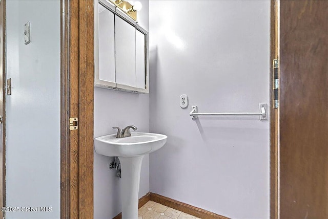 bathroom with baseboards and a sink