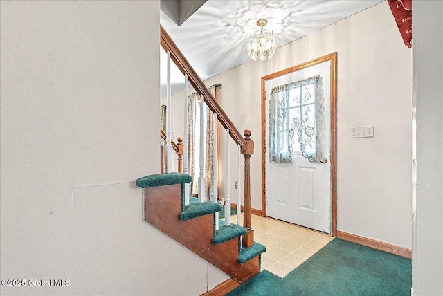 entrance foyer with baseboards, a notable chandelier, and stairway