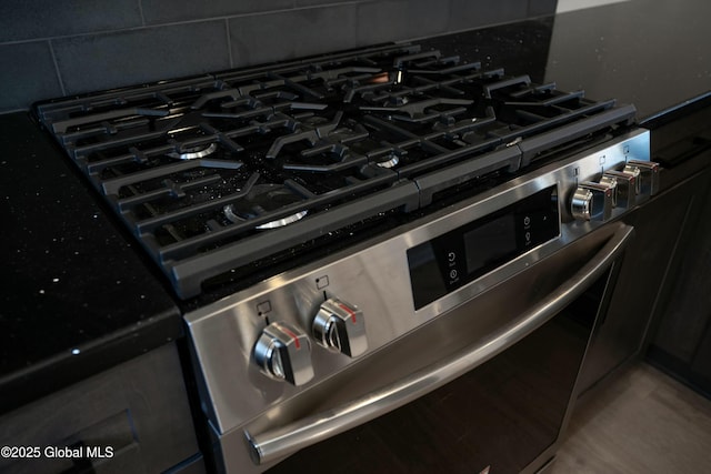 room details featuring backsplash and stainless steel range with gas stovetop
