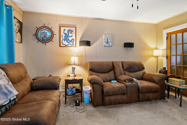 living area with carpet flooring and a ceiling fan