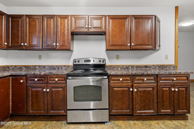 kitchen featuring dark stone countertops and stainless steel electric range
