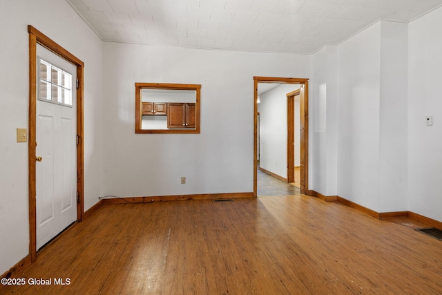 foyer entrance featuring baseboards, visible vents, and light wood-type flooring