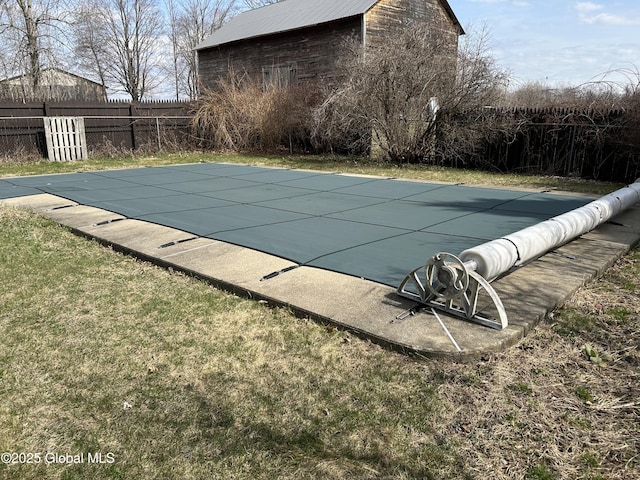 view of swimming pool with fence, a yard, and a fenced in pool
