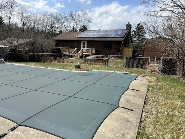 view of pool with fence, a deck, a lawn, and a fenced in pool