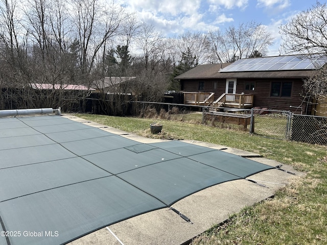 view of swimming pool featuring a deck, a fenced in pool, and a fenced backyard