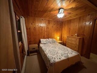 bedroom with wooden walls and wooden ceiling