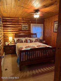 bedroom with wooden ceiling, rustic walls, and ceiling fan