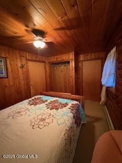 bedroom featuring wooden walls and wood ceiling
