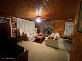 carpeted living area with log walls, ceiling fan, a wood stove, and wooden ceiling