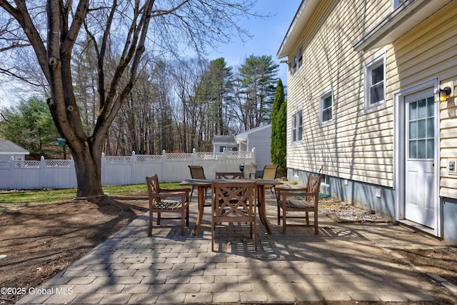 view of patio with outdoor dining area and fence