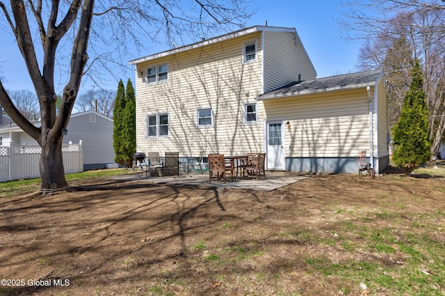 rear view of house featuring a patio and fence