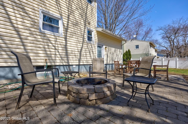 view of patio / terrace with an outdoor fire pit and fence
