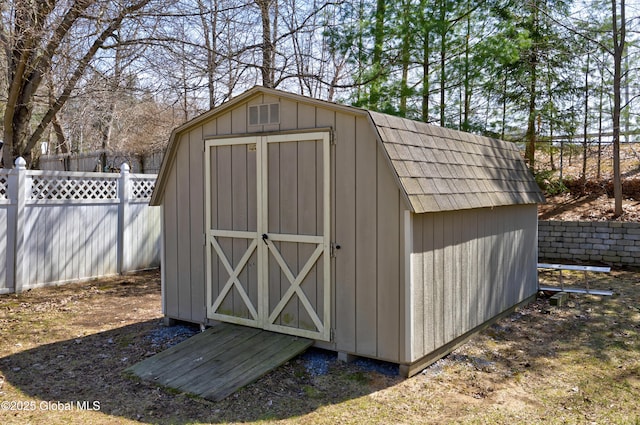 view of shed featuring fence