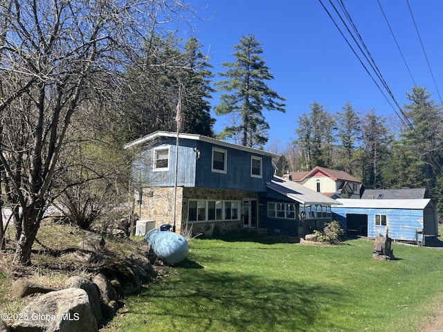 view of front of house featuring a front yard and stone siding